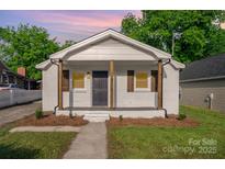 Charming white brick home with inviting front porch and rustic wood columns at 1211 N Boyce St, Gastonia, NC 28052
