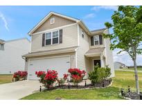 Charming two-story home with a manicured lawn, a two-car garage, and beautiful red roses at 1270 Winding Creek Rd, Salisbury, NC 28146