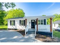 Charming single-story home with white siding, black shutters, and inviting front porch at 1411 Caldwell St, Gastonia, NC 28052
