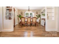 Traditional dining room featuring wood floors, chandelier, and decorative fireplace at 145 Driftwood Dr, Mooresville, NC 28117