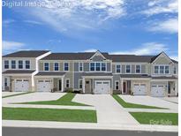 Charming townhome exterior with a one car garage and colorful curb appeal at 1650 Respect Nw St, Concord, NC 28027