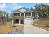 Charming two-story home with gray siding, black shutters, and a welcoming front porch at 1837 Bear St, Charlotte, NC 28214