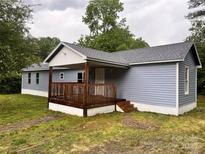 Charming single-story home with a covered front porch and light blue siding at 2131 Barnett St, Lancaster, SC 29720