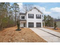 Charming two-story home featuring a white exterior, black accents, and a spacious driveway with a two-car garage at 2813 New Pineola Rd, Charlotte, NC 28208