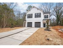 New construction featuring a two-story home with a two-car garage and a modern farmhouse design at 2815 New Pineola Rd, Charlotte, NC 28208