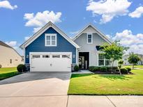 Charming two-story home featuring a manicured lawn, blue and gray siding, and a two-car garage at 3103 Oliver Stanley Trl, Lancaster, SC 29720