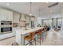 Bright, open kitchen featuring a large island with seating and modern stainless steel appliances at 3132 Stelfox St, Charlotte, NC 28262