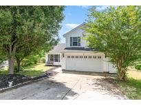 Charming two-story home with a well-maintained lawn, featuring a two-car garage and classic white siding at 4002 Solomons Ct, Monroe, NC 28110
