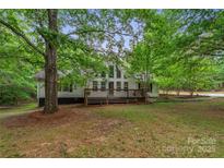 Charming two-story home with a large front deck and plenty of shade trees at 4038 Forest Brook Dr, Edgemoor, SC 29712