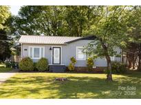 Charming single-story home with mature trees, tidy landscaping, and a light gray exterior at 5014 Oxford School Rd, Claremont, NC 28610