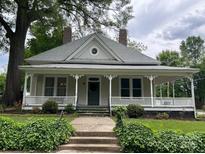 Charming home featuring a large, inviting front porch and well-maintained landscaping at 531 Walnut St, Statesville, NC 28677