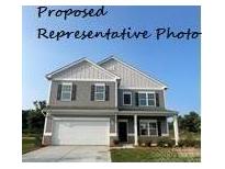 Charming two-story home featuring a classic design with a front-facing garage and welcoming porch at 6308 Honor Ave, Midland, NC 28107