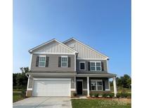 Charming two-story home with gray siding, white trim, and a two-car garage at 6308 Honor Ave, Midland, NC 28107