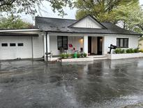 Charming brick home features a covered porch and attached garage at 713 Sloop Ave, Kannapolis, NC 28083