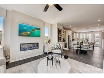 Open-concept living room with modern fireplace, large screen tv, and stylish furniture at 743 Hoke Ln, Davidson, NC 28036