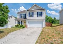 Two-story home with blue shutters, yellow door, and two-car garage on a sunny day at 937 Anchor Ne Way, Kannapolis, NC 28083