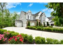 Beautiful two-story home with a lush front yard and long driveway leading to a three-car garage at 9596 Pacing Nw Ln, Concord, NC 28027