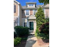 Charming townhome featuring a well-manicured front yard and a welcoming dark green front door at 10649 Trolley Run Dr, Cornelius, NC 28031