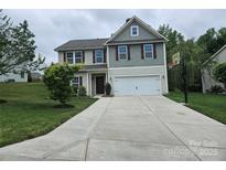 Charming two-story home with a landscaped yard, a long driveway, and a basketball hoop at 1071 Bassett Way, Fort Mill, SC 29707