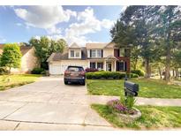 Charming two-story home featuring a well-manicured lawn, inviting entrance, and attached two-car garage at 10804 Back Ridge Rd, Charlotte, NC 28277