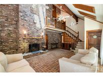 Spacious living room featuring a striking brick fireplace, vaulted ceiling, and loft area with wooden accents at 1160 Walton Pl, Salisbury, NC 28146