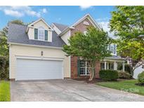 Charming two-story home with a well-manicured front yard and attached two-car garage at 1308 Pennington Nw Pl, Concord, NC 28027