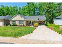 Charming single-story brick home with a well-manicured lawn and a welcoming front porch at 137 Ole Eastpointe Dr, York, SC 29745