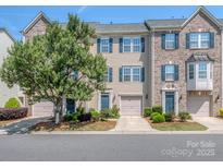 Charming townhome with well-maintained landscaping, a garage, and a welcoming entryway at 2125 Belle Vernon Ave, Charlotte, NC 28210