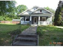 Charming home with a welcoming front porch and well-maintained yard at 216 N Rowan Ave, Spencer, NC 28159