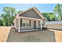 Charming single-story home featuring a covered front porch and a mix of vinyl and shingle siding at 2506 Glendale Ave, Kannapolis, NC 28081
