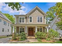 Charming two-story home with a welcoming front porch, manicured landscaping, and classic architectural details at 2617 Bay St, Charlotte, NC 28205