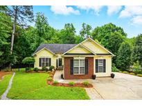 Charming home featuring manicured lawn and flowerbeds in a peaceful, wooded neighborhood at 2745 Stockwood Dr, Gastonia, NC 28056