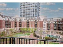 Beautiful courtyard view with pool and gazebo, surrounded by multi-story residences at 300 W 5Th St # 404, Charlotte, NC 28202