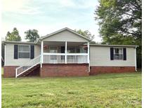 Charming single-story home with a inviting front porch and well-maintained lawn at 3154 Loomis St, Lincolnton, NC 28092