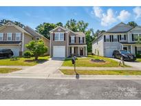 Charming two-story home featuring neutral siding, red shutters, a manicured lawn, and attached single-car garage at 6430 Matlea Ct, Charlotte, NC 28215