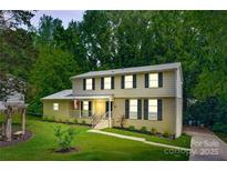 Charming two-story home with a well-manicured lawn and inviting front porch at 7016 Wannamaker Ln, Charlotte, NC 28226
