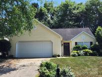 Charming home with a two-car garage, mature trees, and well-maintained landscaping at 14343 Arbor Ridge Dr, Charlotte, NC 28273