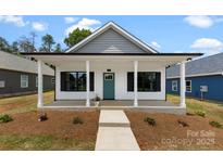 Charming single-story home with a welcoming covered porch, complete with elegant columns and a neatly landscaped front yard at 213 Benfield Rd, Kings Mountain, NC 28086