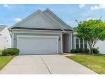 Charming home with a two-car garage, well-maintained lawn, and attractive landscaping at 3043 Santee Ct, Fort Mill, SC 29707