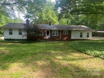 Charming single story home featuring a brick facade and covered carport at 3933 Planters Pl, Indian Trail, NC 28079