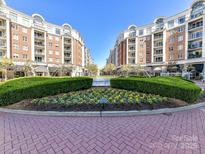 Beautiful exterior view of brick buildings, lush landscaping, and brick paved area at 4625 Piedmont Row Dr # 410, Charlotte, NC 28210