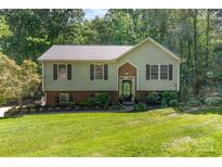 Charming two-story home with green lawn and mature trees at 4700 Hickory Grove Rd, Mount Holly, NC 28120