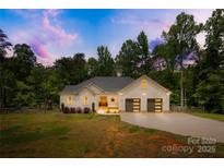 Charming home with a well-manicured lawn, two-car garage, and inviting front entrance at 5615 American Way, Denver, NC 28037