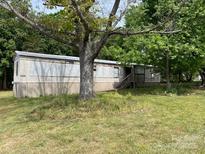 Cozy single-story home featuring neutral siding, well-kept lawn, and mature trees at 6504 Denver Heights Cir, Denver, NC 28037