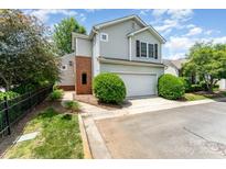 Charming two-story home with a two-car garage, well-manicured landscaping, and brick chimney at 8734 Meadowmont View Dr, Charlotte, NC 28269