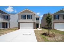 Charming two-story home with stone accents, attached two-car garage and newly poured driveway at 1027 Hostler Ln, York, SC 29745