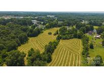 An aerial view of a vast lot with partially cleared land and trees around its perimeter at 1040 Nc 90 W Hwy, Taylorsville, NC 20681