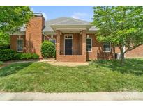 Charming brick home with a well-manicured lawn and inviting front porch at 1141 Ardwyck Pl, Rock Hill, SC 29730