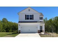 Two-story home boasts a clean white facade, complemented by a two car garage and well-manicured lawn at 1546 Doran Ter, Richburg, SC 29729