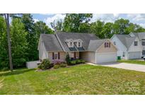 Charming single-Gathering home featuring a two-car garage, manicured lawn, and decorative dormers at 208 N Kayla Dr, Salisbury, NC 28146